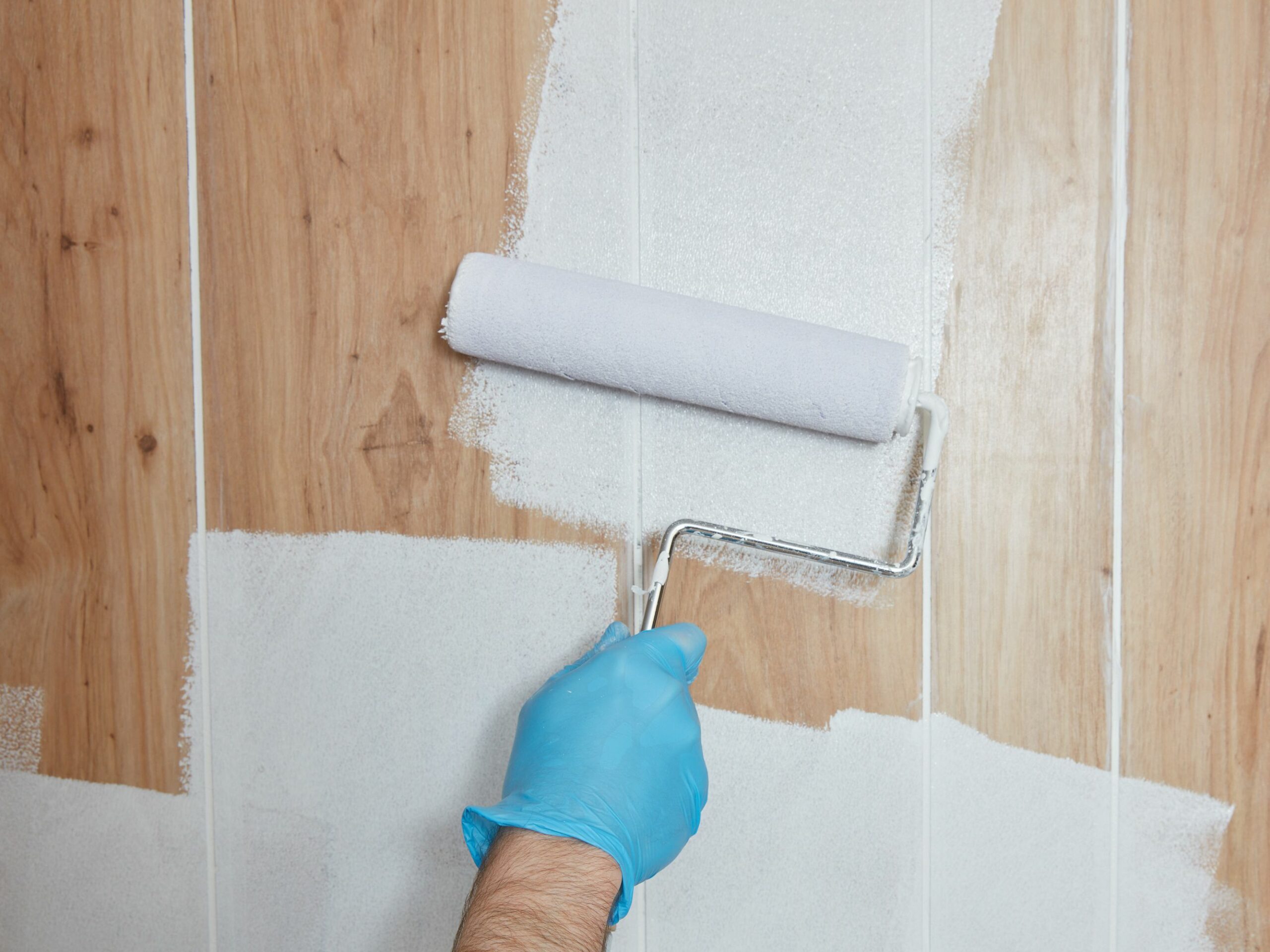 painting the wood panel walls of your house using white paint